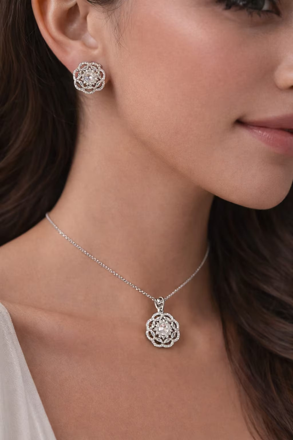 Floral diamond silver pendant set worn by model.