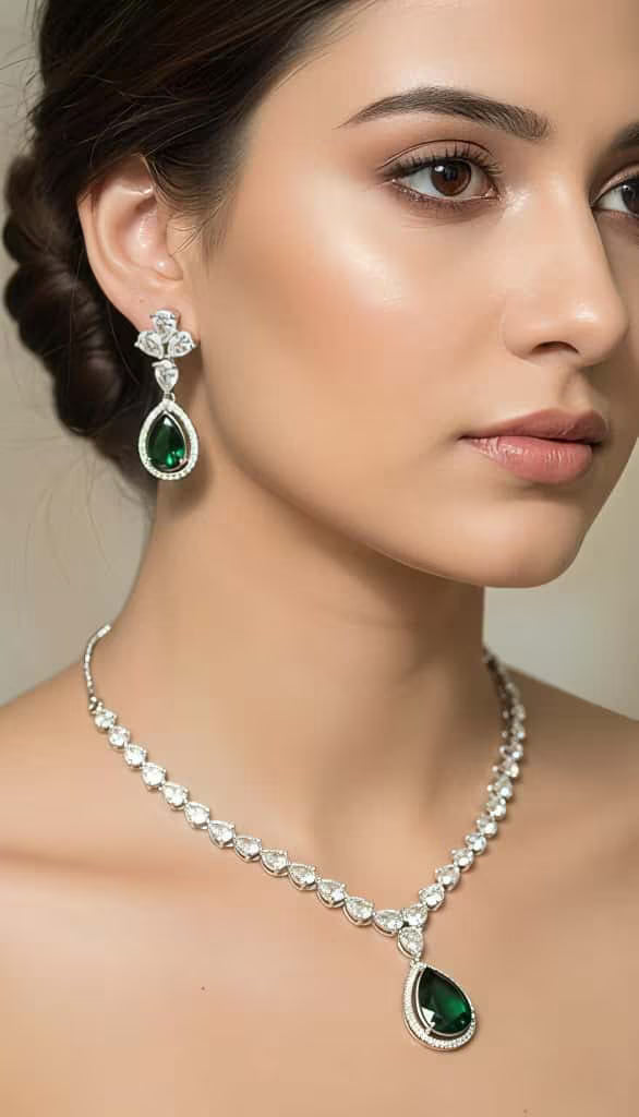 Green teardrop zircon necklace set with leaf design in silver finish by Karat India