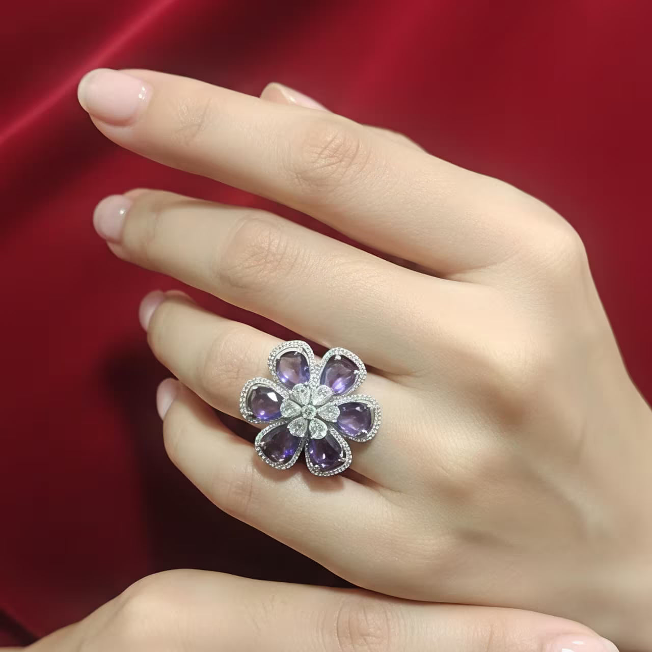 Silver floral statement ring with purple stones and white zircon center