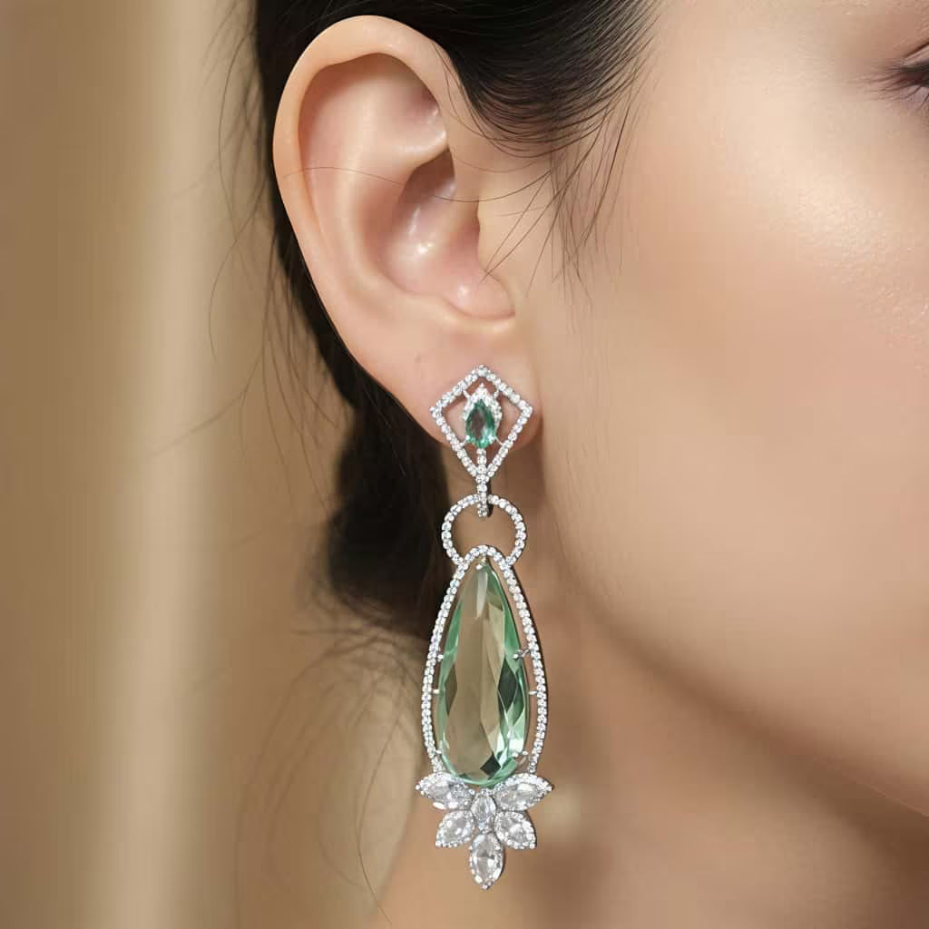 Long emerald silver drop earrings with AAA zirconia stones by Karat India