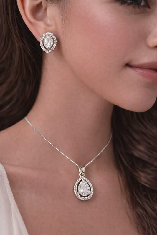 Classic teardrop diamond jewellery look silver pendant set worn by woman
