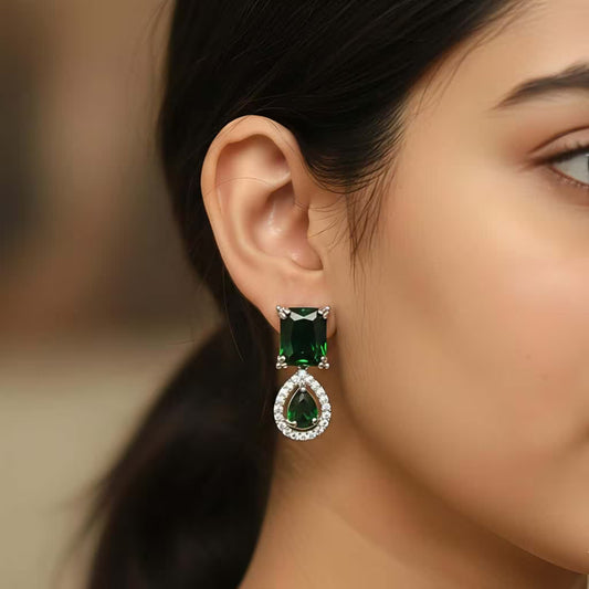 Emerald green drop earrings with zircon halo and silver finish party wear design