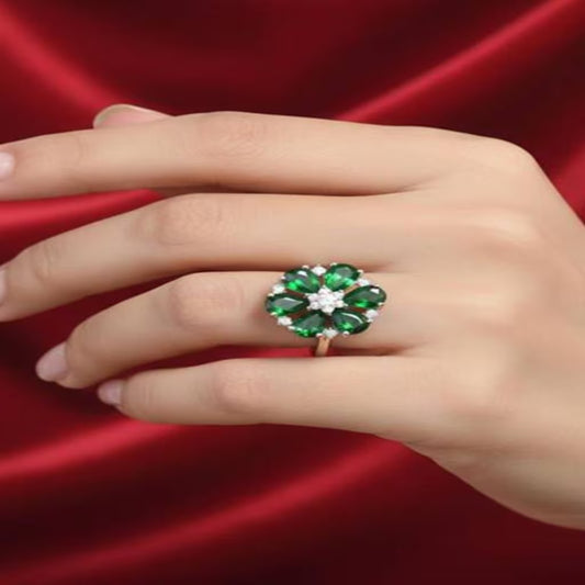 Emerald green floral silver ring with white zircon stones worn on hand