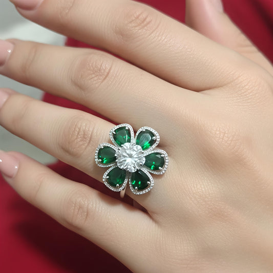 Silver floral statement ring with emerald green stones and white zircon center