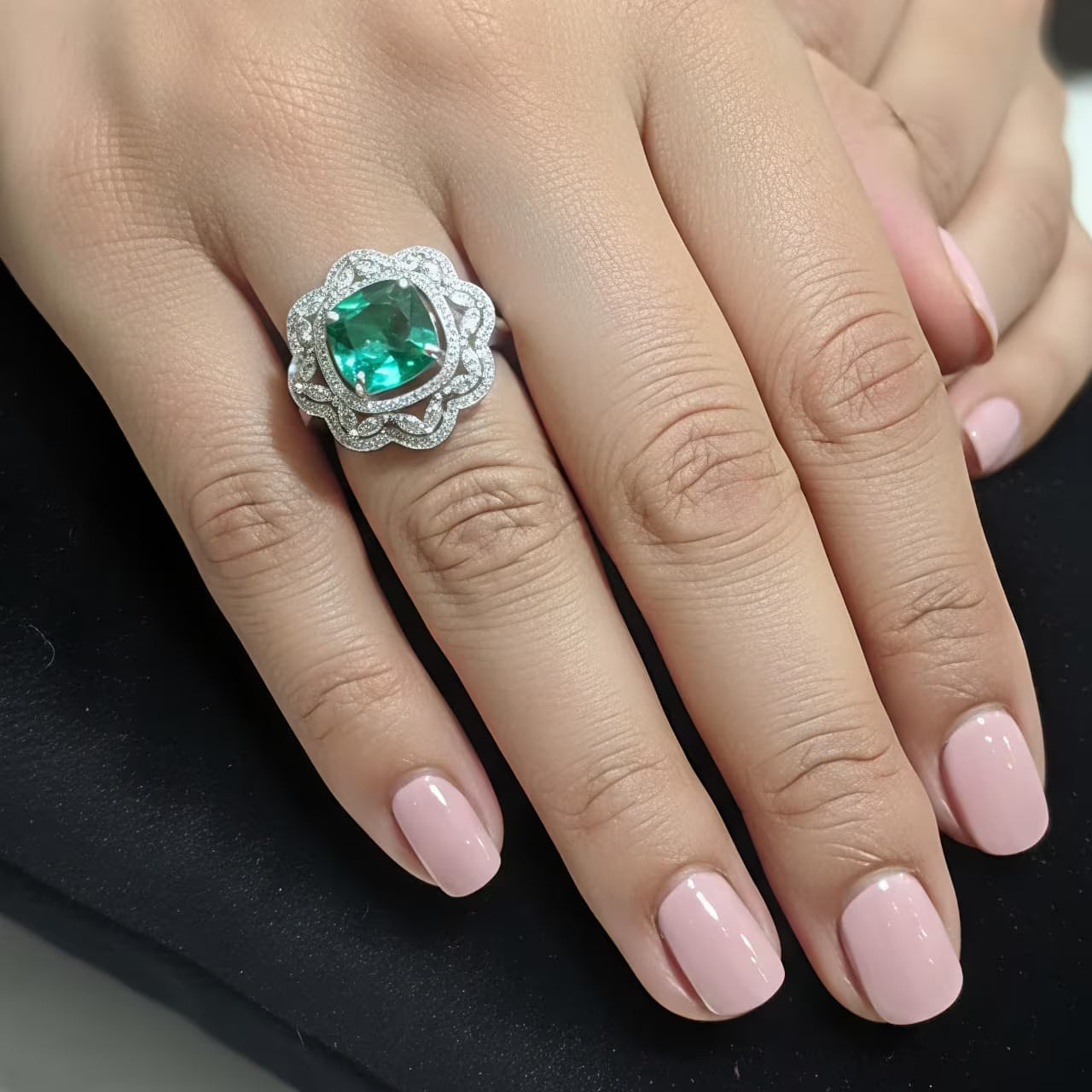 Emerald green cushion cut stone silver ring with floral zircon swirl design