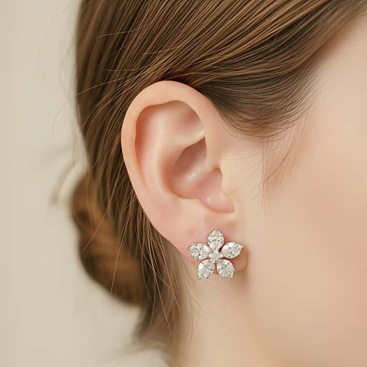 Close up view of floral silver stud earrings with AAA zirconia stones by Karat India