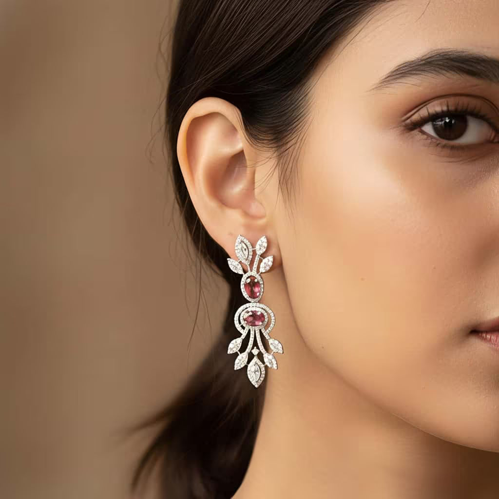 Silver dangle earrings with ruby red stones and leaf floral design