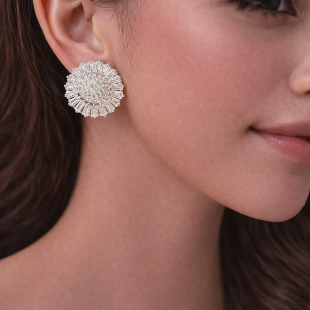 Round diamond look silver stud earrings worn by a woman