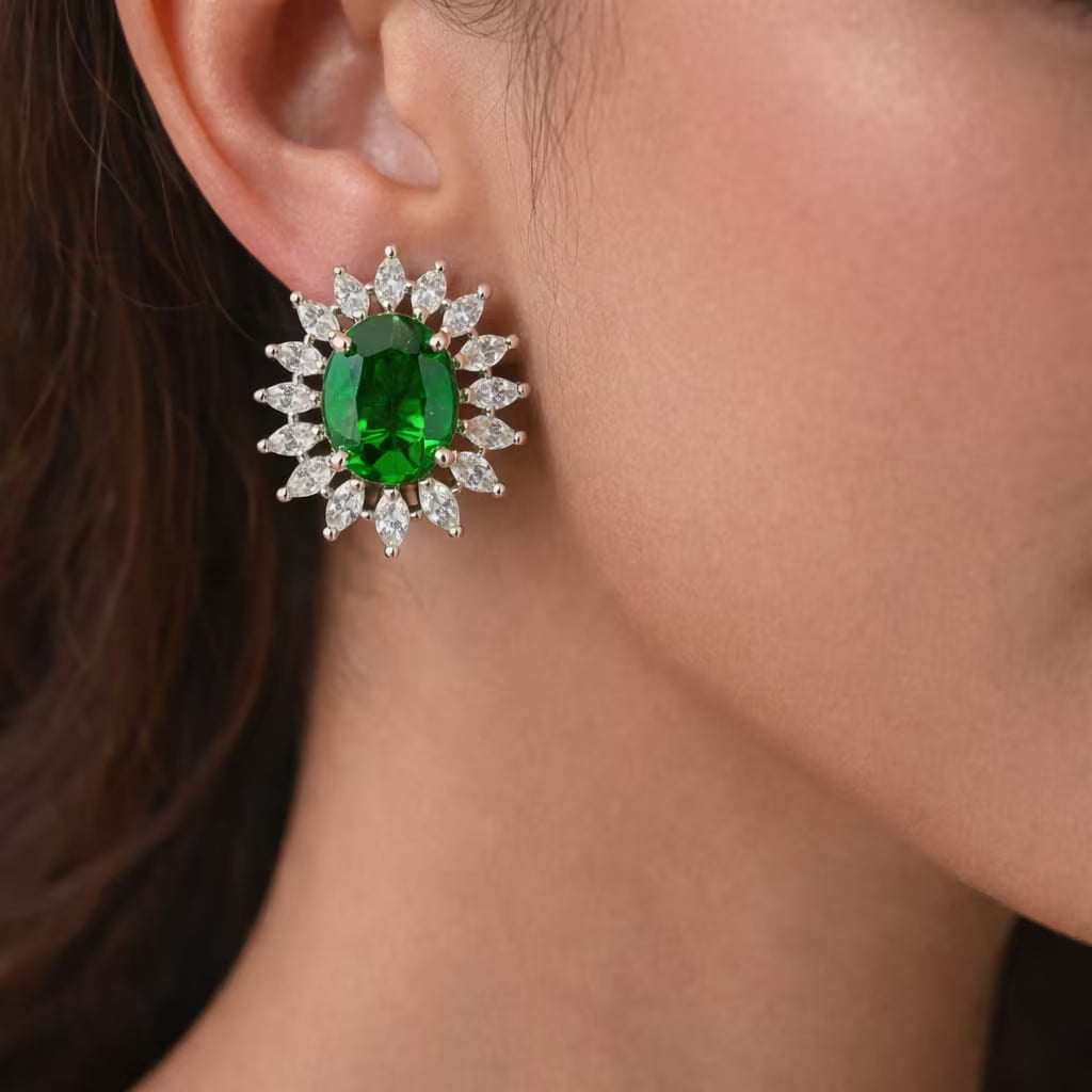 Royal green stone stud earrings with diamond halo design worn on ear
