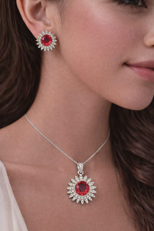 Ruby red diamond halo pendant set with matching earrings worn on model