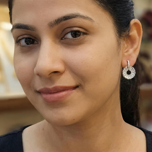 Silver diamond floral drop earrings worn by a woman, elegant sterling silver jewellery
