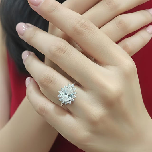 
Silver floral statement ring with oval white zircon stone and halo flower design on finger
